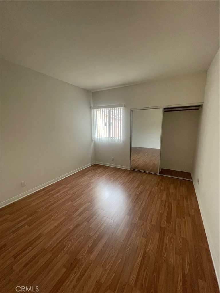 10010 Reseda Boulevard, Unit D Northridge, CA 91324 - Photo 12 of 22 a view of wooden floor and windows in a room