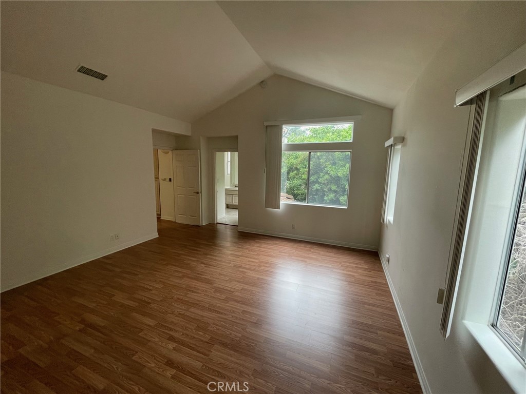 10010 Reseda Boulevard, Unit D Northridge, CA 91324 - Photo 16 of 22 an empty room with wooden floor and windows