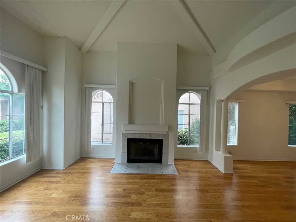 10010 Reseda Boulevard, Unit D Northridge, CA 91324 - Photo 5 of 22 an empty room with wooden floor fireplace and windows