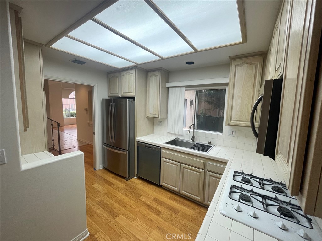 10010 Reseda Boulevard, Unit D Northridge, CA 91324 - Photo 7 of 22 a kitchen with stainless steel appliances a refrigerator and a stove