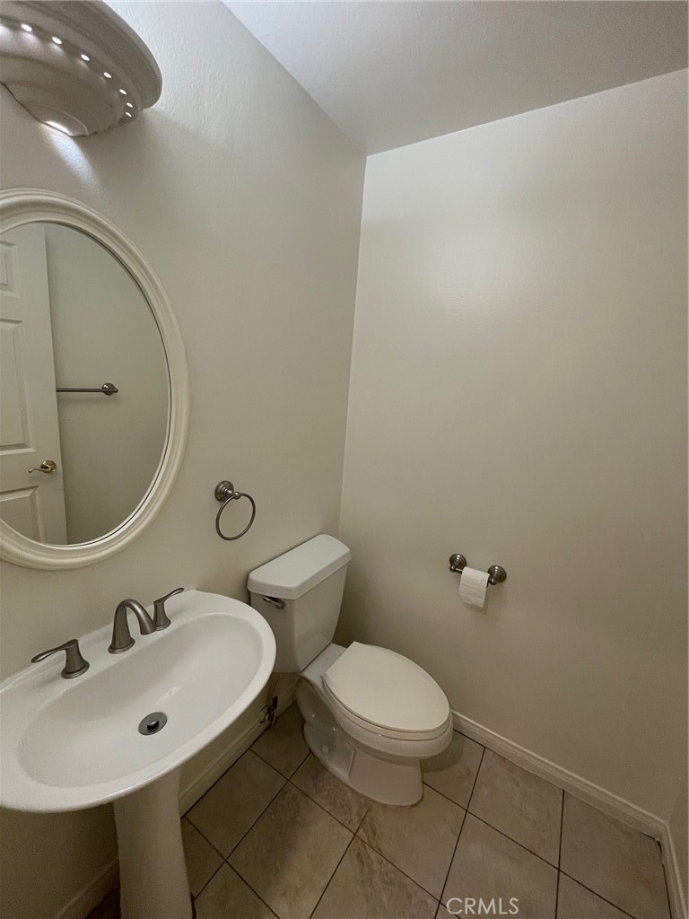 10010 Reseda Boulevard, Unit D Northridge, CA 91324 - Photo 9 of 22 a bathroom with a toilet a sink and mirror