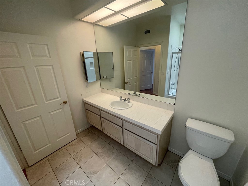 10010 Reseda Boulevard, Unit D Northridge, CA 91324 - Photo 10 of 22 a bathroom with a sink toilet and mirror