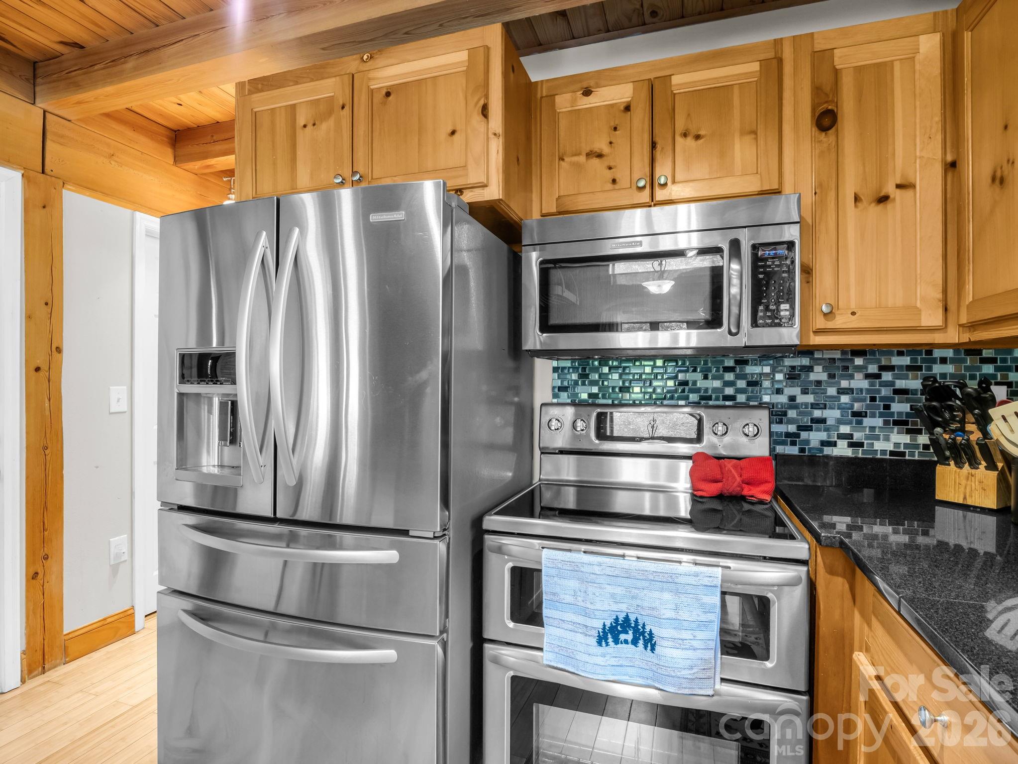 165 Dream Road Hendersonville, NC 28792 - Photo 15 of 46 a kitchen with stainless steel appliances granite countertop a refrigerator and a stove