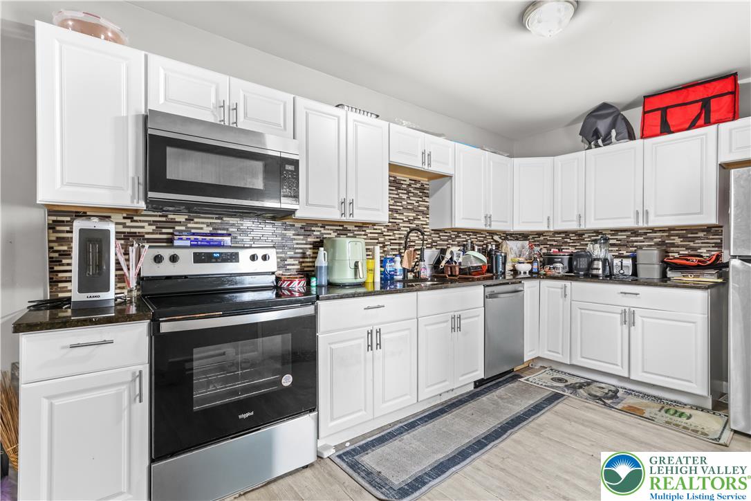 12 South Front Street Coplay, PA 18037 - Photo 9 of 41 This updated kitchen features ample cabinetry and modern appliances, perfect for everyday living.