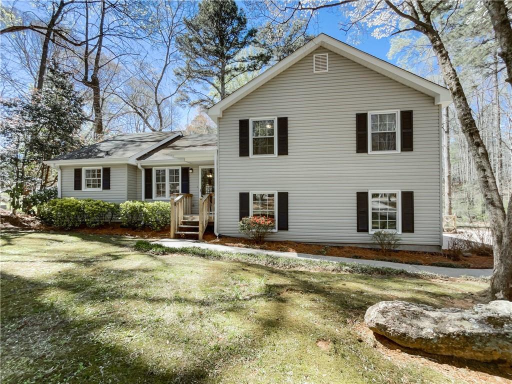 a view of house with yard