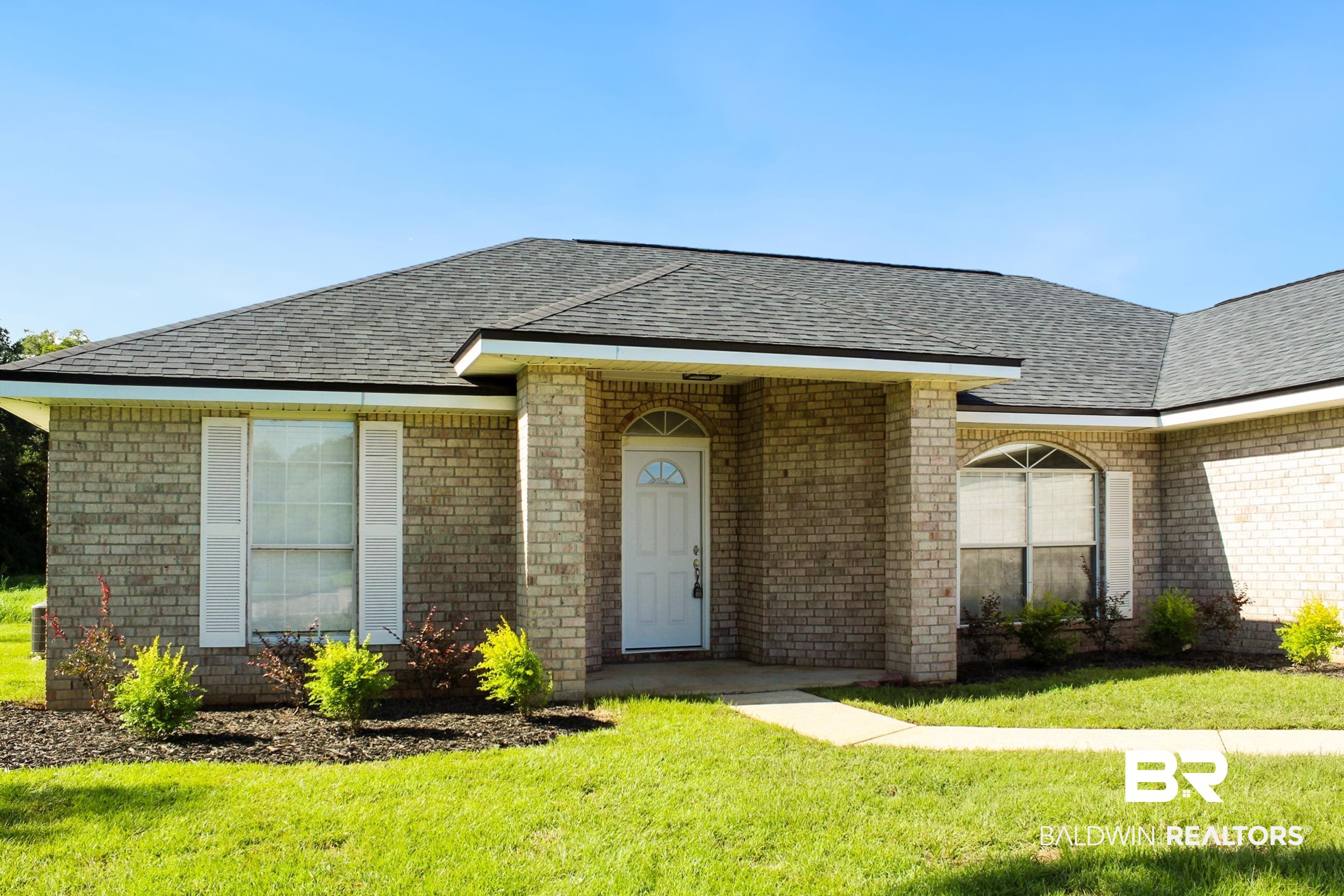 14750 Pawnee Court Foley, AL 36535 - Photo 7 of 34 Single story home with brick siding, roof with shingles, and a front lawn