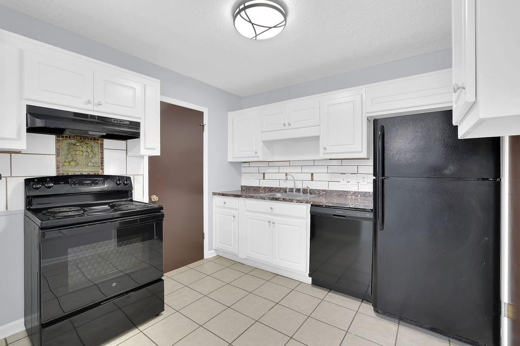 1424 Springleaf Circle Southeast Smyrna, GA 30080 - Photo 15 of 38 a kitchen with stainless steel appliances granite countertop a refrigerator and a stove top oven