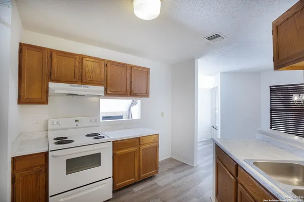 a kitchen with a sink stove and cabinets