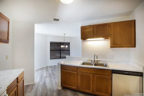a kitchen with sink a microwave and cabinets
