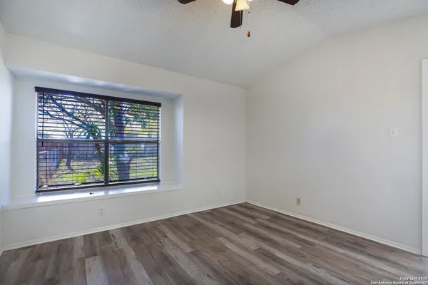 an empty room with a empty space and windows