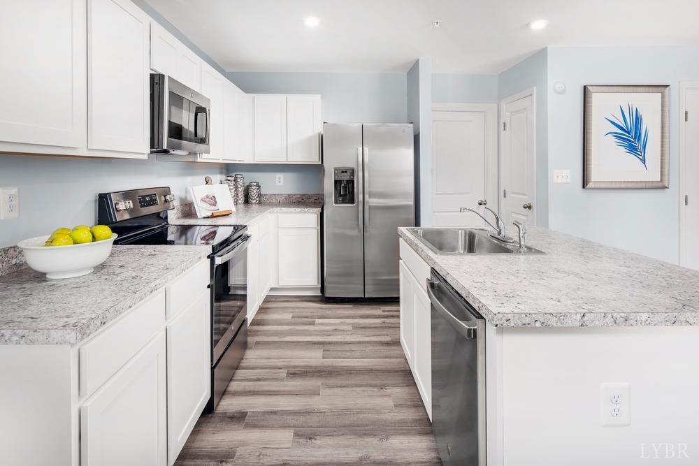 236 Thicket Drive Lynchburg, VA 24501 - Photo 5 of 16 a kitchen with stainless steel appliances granite countertop a sink stove and refrigerator