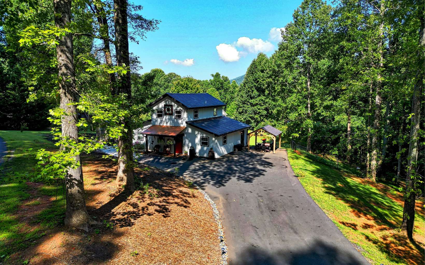 2255 Hy Top Road Young Harris, GA 30582 - Photo 4 of 65 a view of a wooden house with a yard and plants