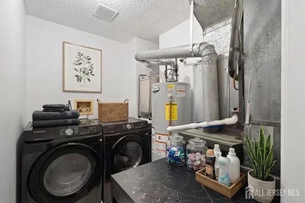 a utility room with sink dryer and washer