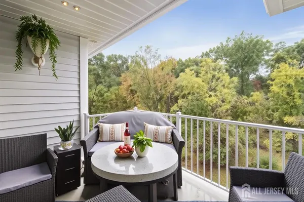 a balcony with furniture and a potted plant