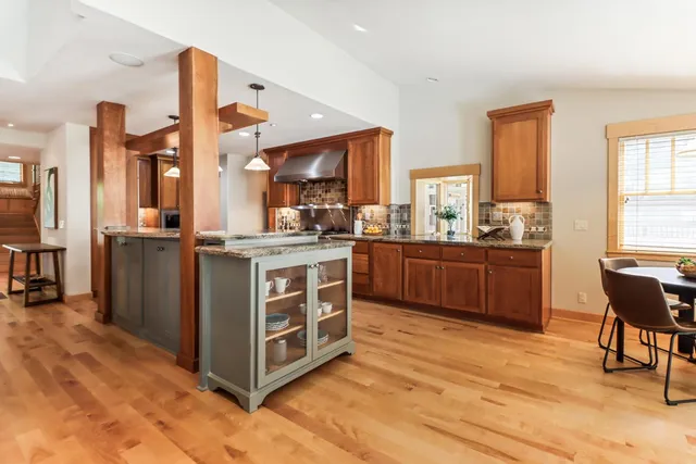 a large kitchen with a large window and stainless steel appliances