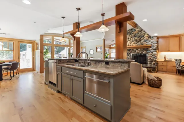 a view of a hallway with wooden floor and windows