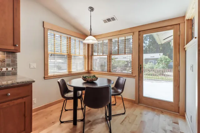 a large bed sitting in a room next to a window