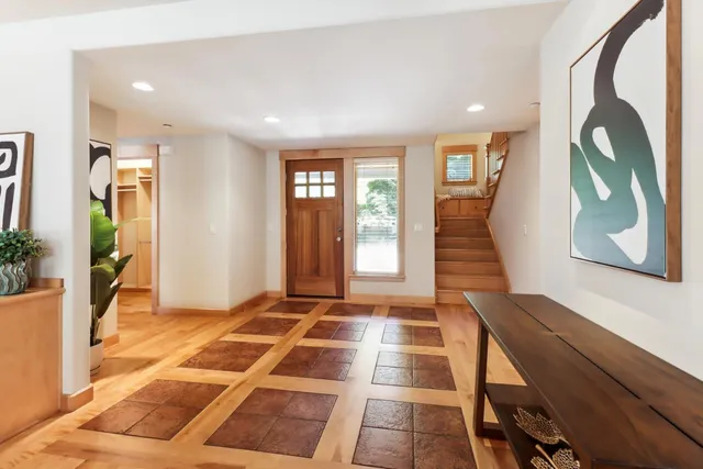a view of a kitchen with stainless steel appliances granite countertop a stove and a refrigerator