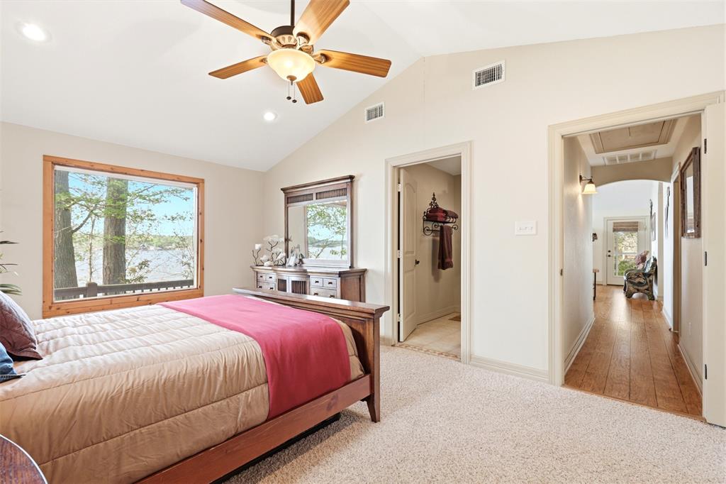 307 South Park Road Scroggins, TX 75480 - Photo 17 of 33 a spacious bedroom with a bed and a chandelier