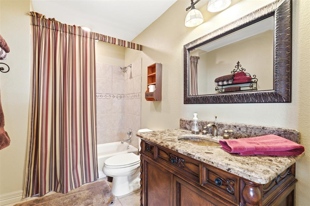 307 South Park Road Scroggins, TX 75480 - Photo 18 of 33 a bathroom with a granite countertop sink and a mirror