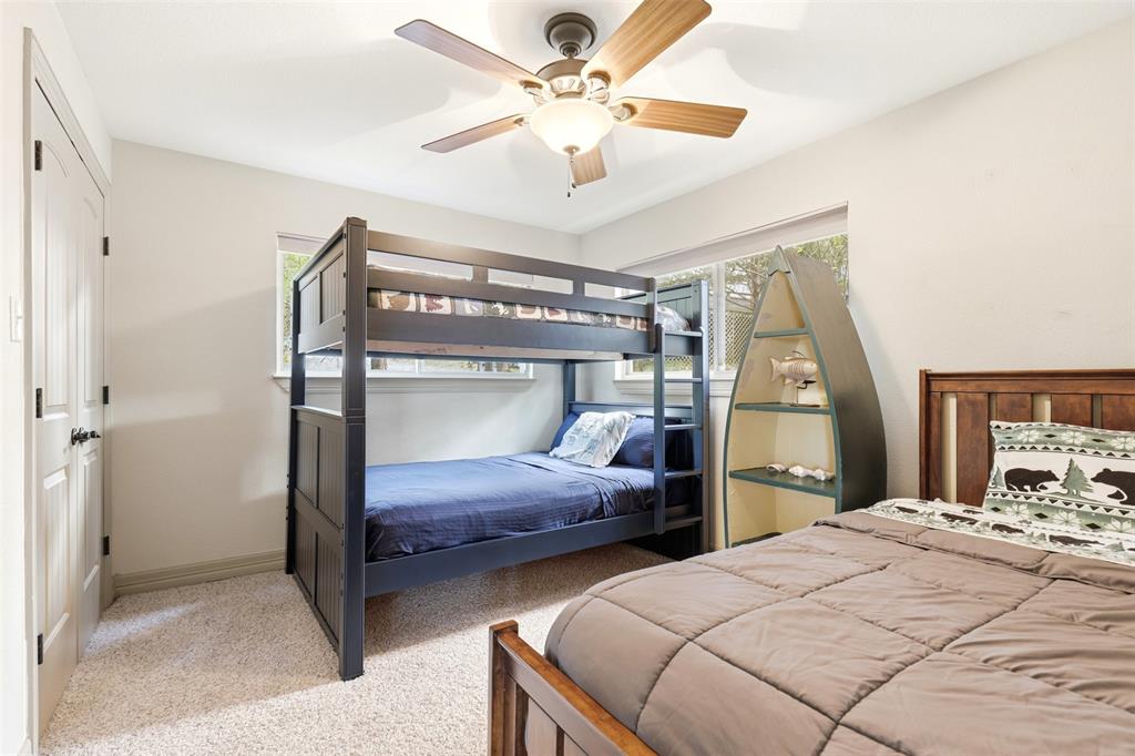 307 South Park Road Scroggins, TX 75480 - Photo 19 of 33 a bedroom with two bed and a chandelier