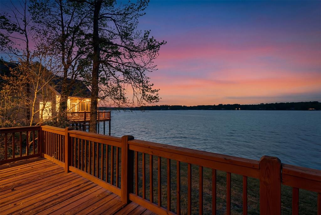 307 South Park Road Scroggins, TX 75480 - Photo 2 of 33 a balcony with wooden floor and lake view