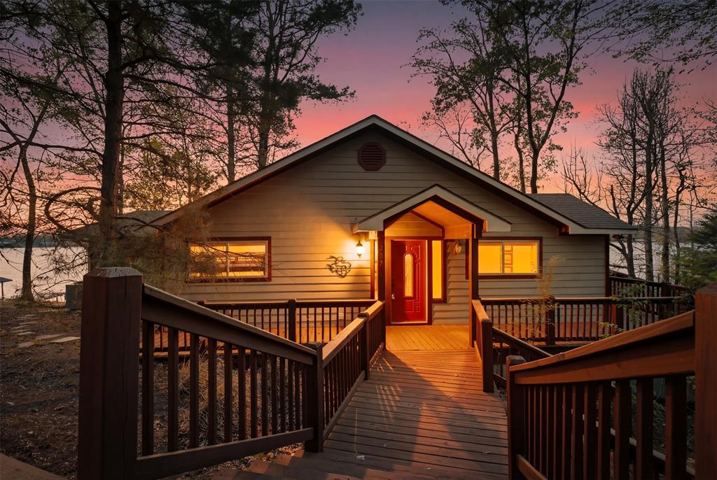 307 South Park Road Scroggins, TX 75480 - Photo 5 of 33 a view of wooden house with a small yard and wooden fence