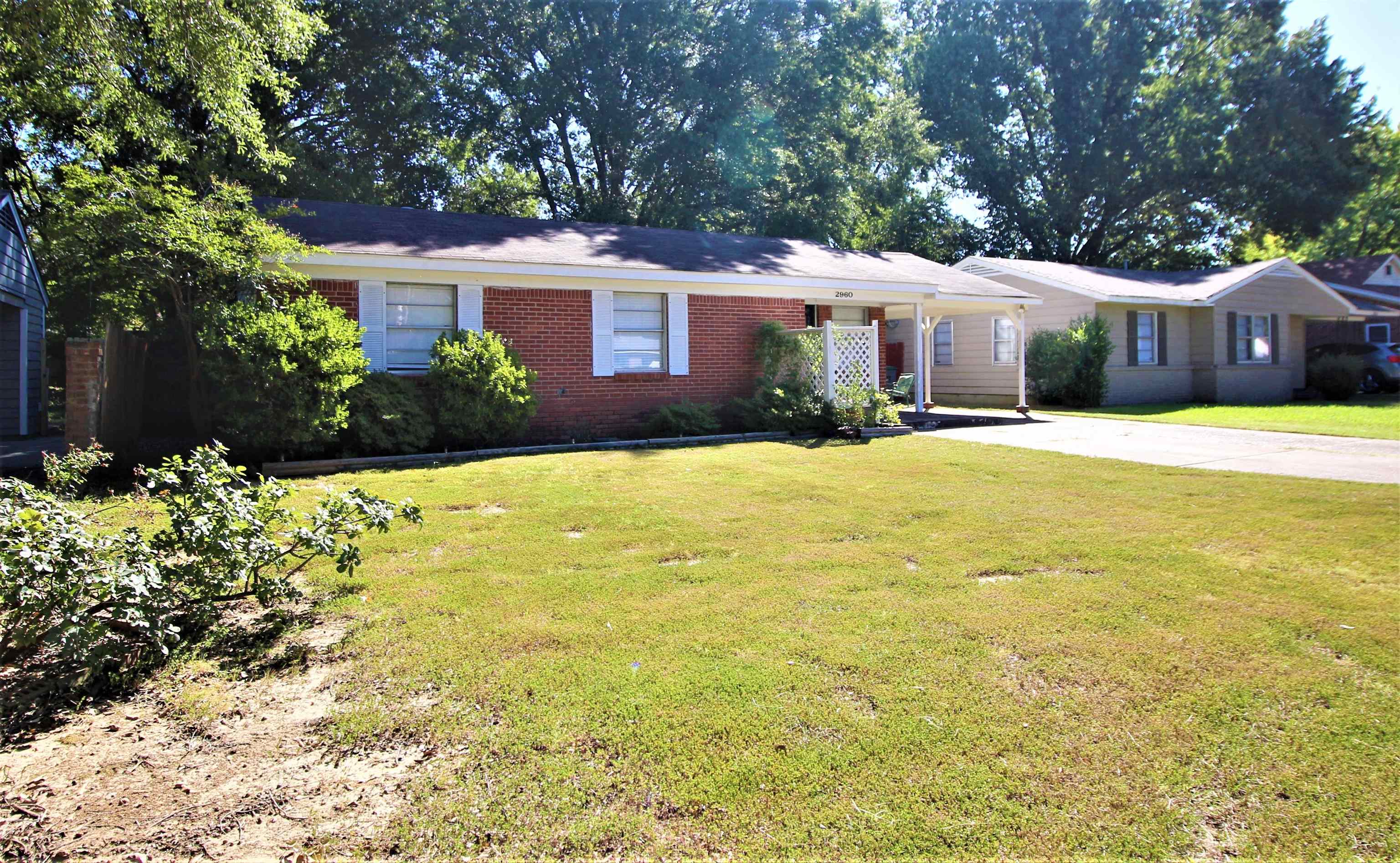 2960 Cherry Road Memphis, TN 38118 - Photo 3 of 16 a front view of a house with a yard and trees