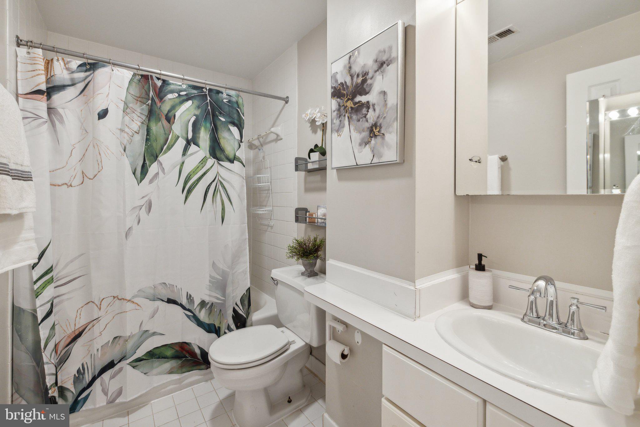 1621 T Street Northwest, Unit 307 Washington, DC 20009 - Photo 10 of 15 a bathroom with a sink a toilet and shower curtain