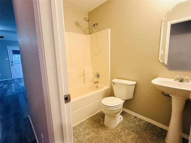 a bathroom with a toilet sink and a mirror
