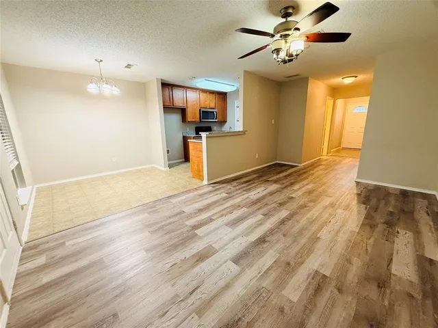 a view of a kitchen with a sink and a refrigerator