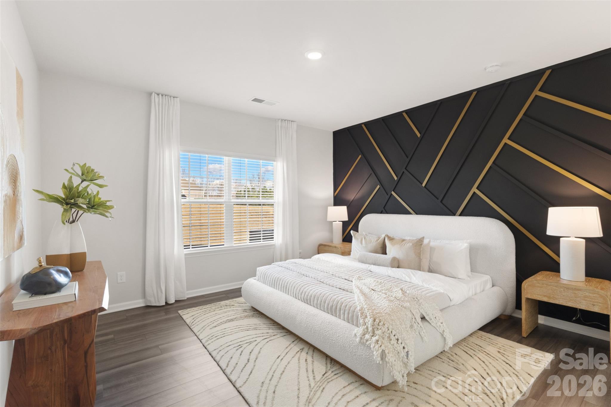 15224 Lake Ridge Road Charlotte, NC 28278 - Photo 13 of 32 a bedroom with a bed and a potted plant