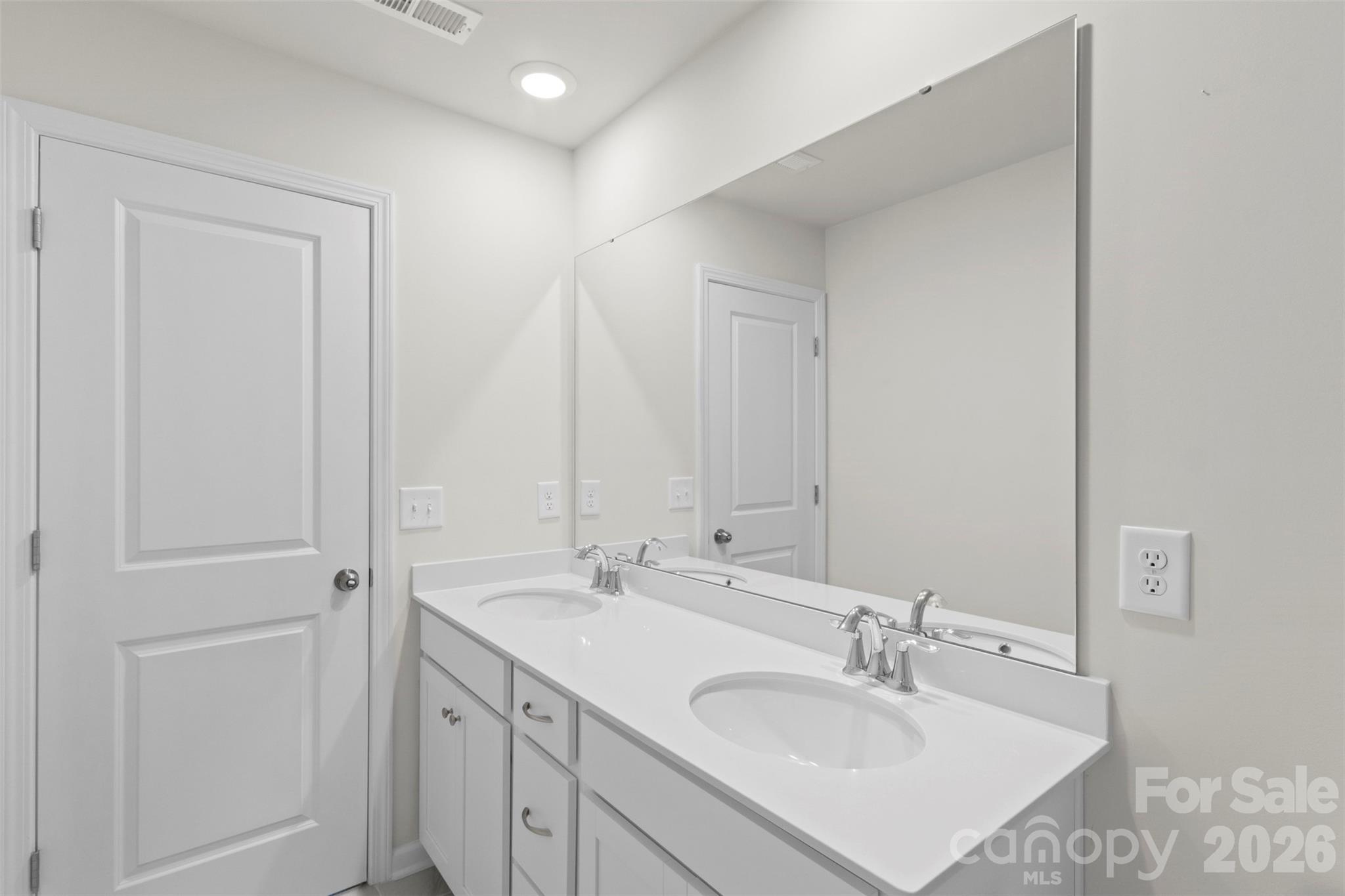 15224 Lake Ridge Road Charlotte, NC 28278 - Photo 25 of 32 a bathroom with 2 sink and a mirror