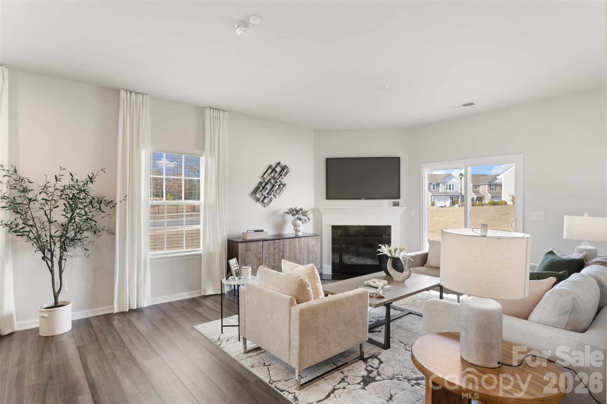 15224 Lake Ridge Road Charlotte, NC 28278 - Photo 3 of 32 a living room with furniture a fireplace and a potted plant