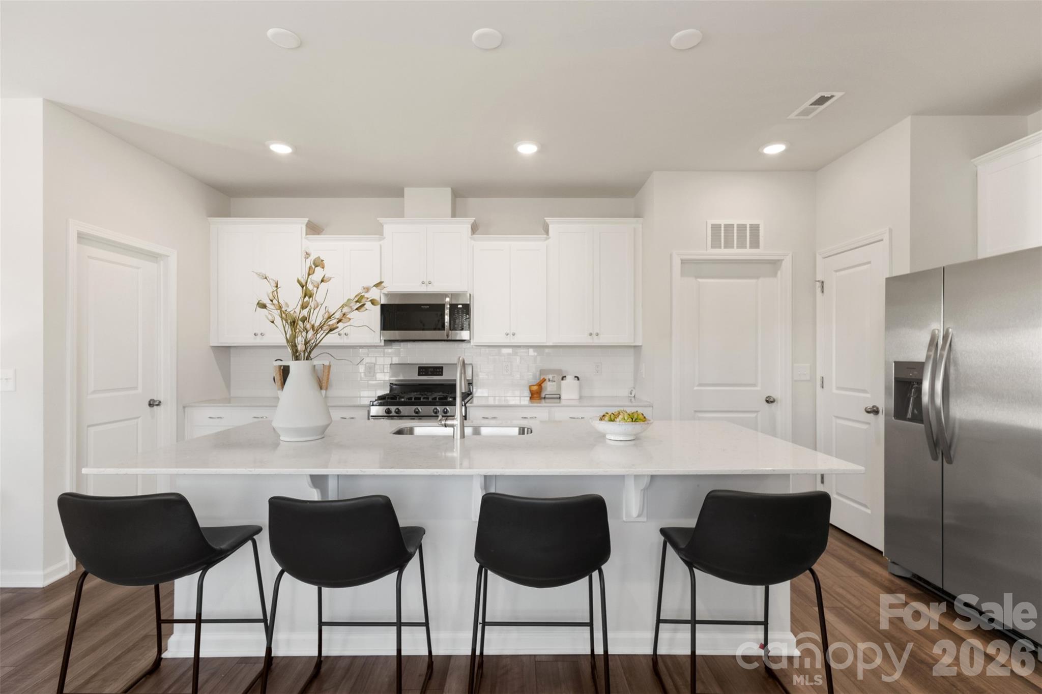 15224 Lake Ridge Road Charlotte, NC 28278 - Photo 8 of 32 a kitchen with granite countertop a counter space chairs stainless steel appliances and cabinets