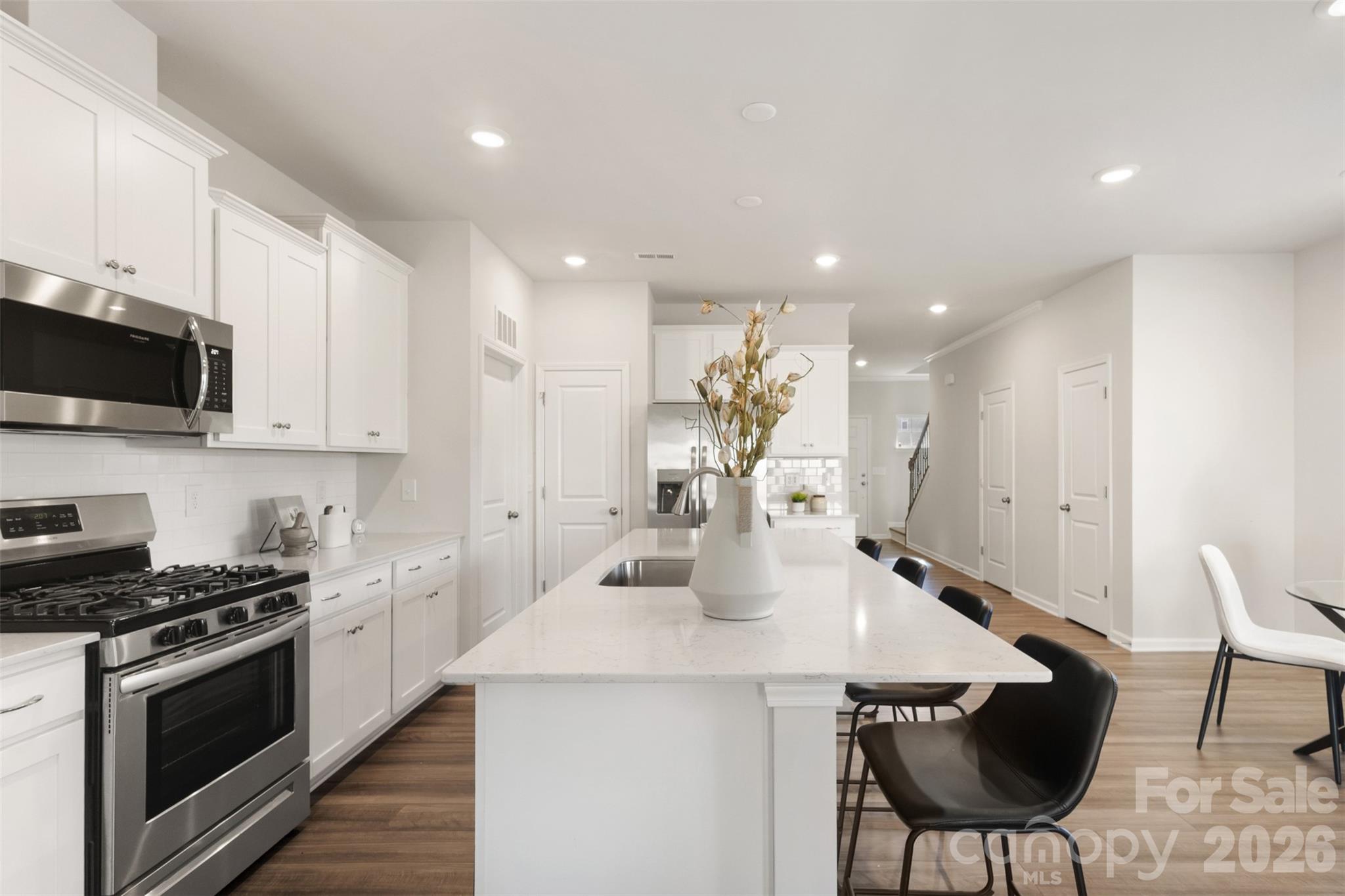 15224 Lake Ridge Road Charlotte, NC 28278 - Photo 10 of 32 a kitchen with stainless steel appliances kitchen island granite countertop a sink and a stove