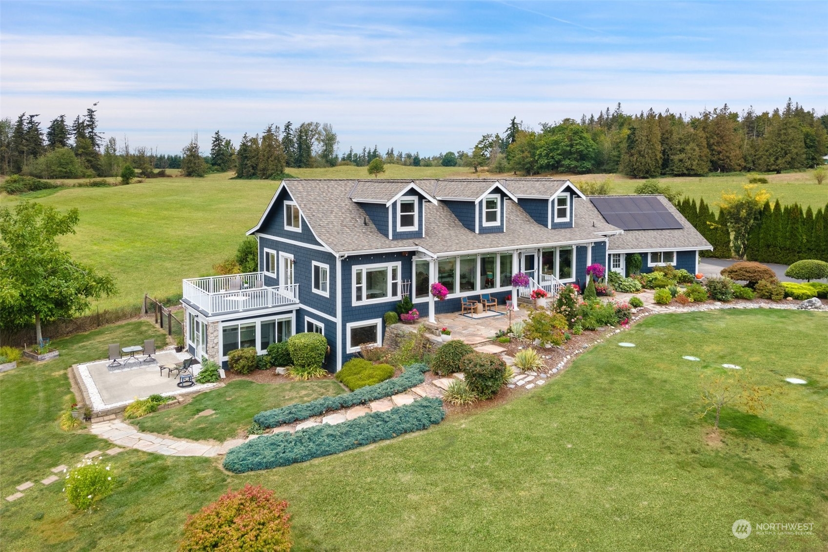 an aerial view of residential houses with yard and lake view