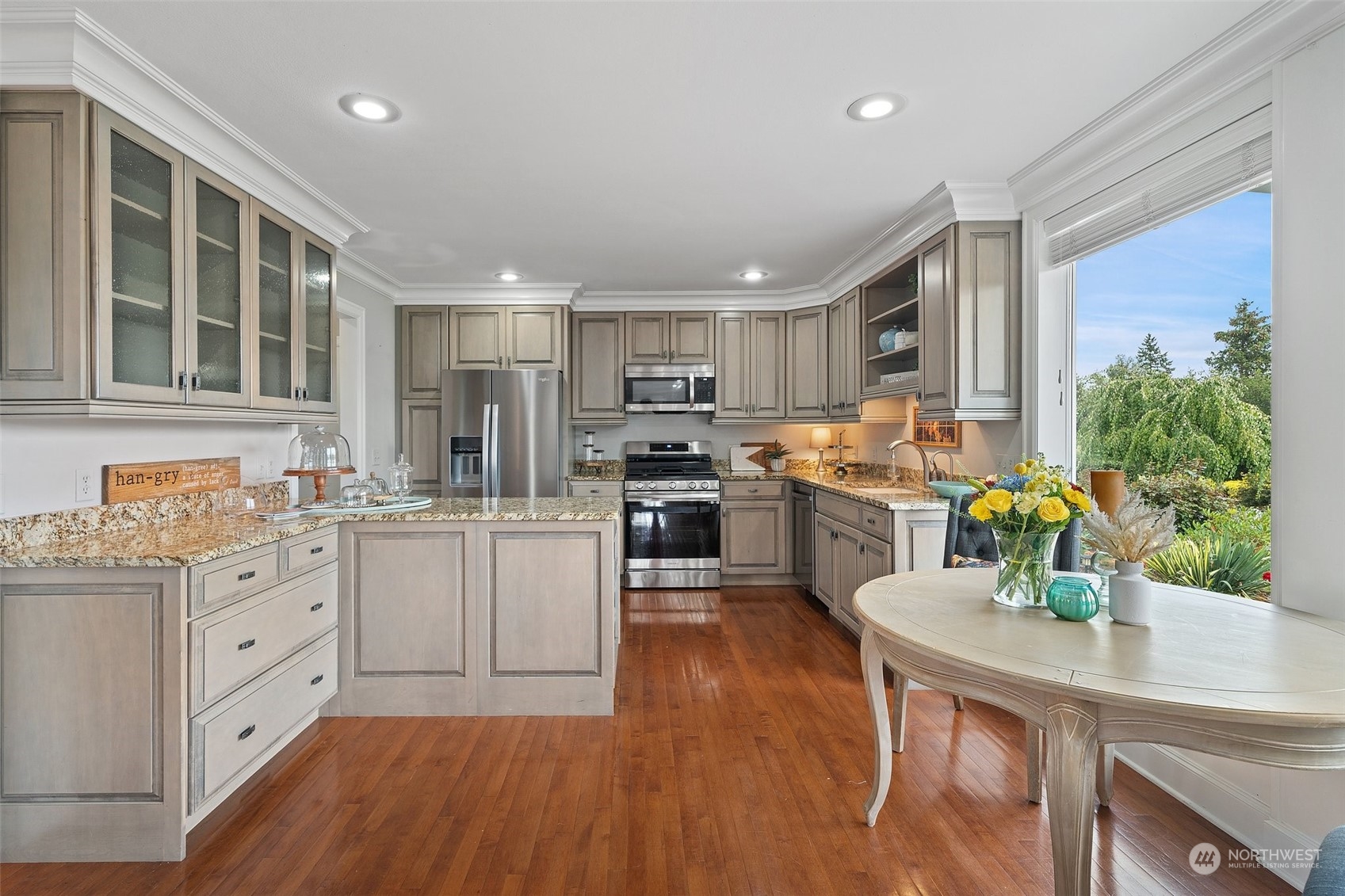 9435 Weidkamp Road Lynden, WA 98264 - Photo 12 of 40 a kitchen with white cabinets and stainless steel appliances
