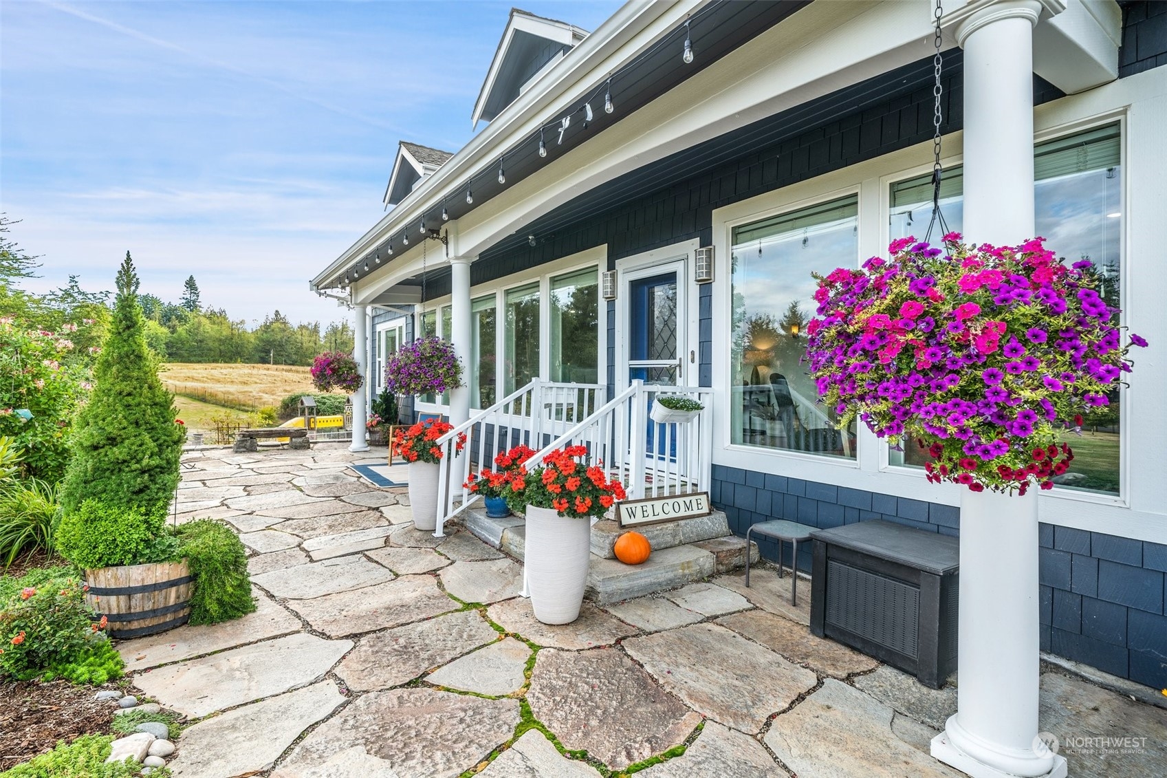 9435 Weidkamp Road Lynden, WA 98264 - Photo 3 of 40 a front view of a house with outdoor seating