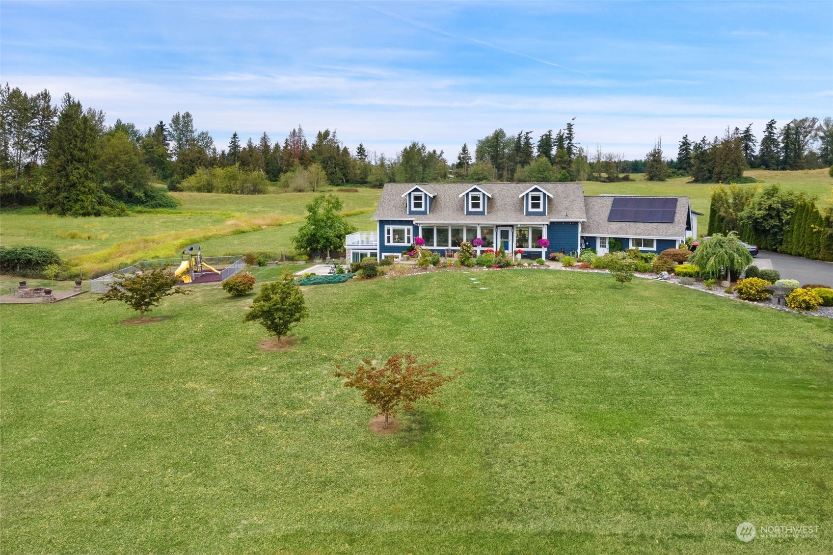 9435 Weidkamp Road Lynden, WA 98264 - Photo 34 of 40 an aerial view of residential houses with outdoor space and trees