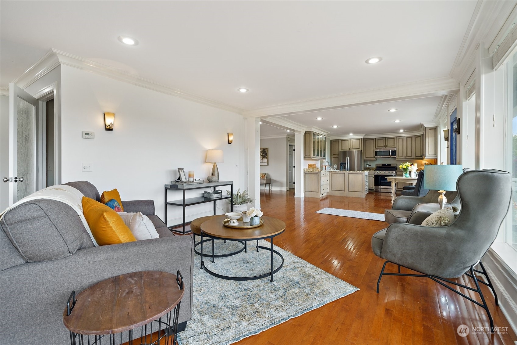 9435 Weidkamp Road Lynden, WA 98264 - Photo 9 of 40 a living room with furniture and a dining table with wooden floor