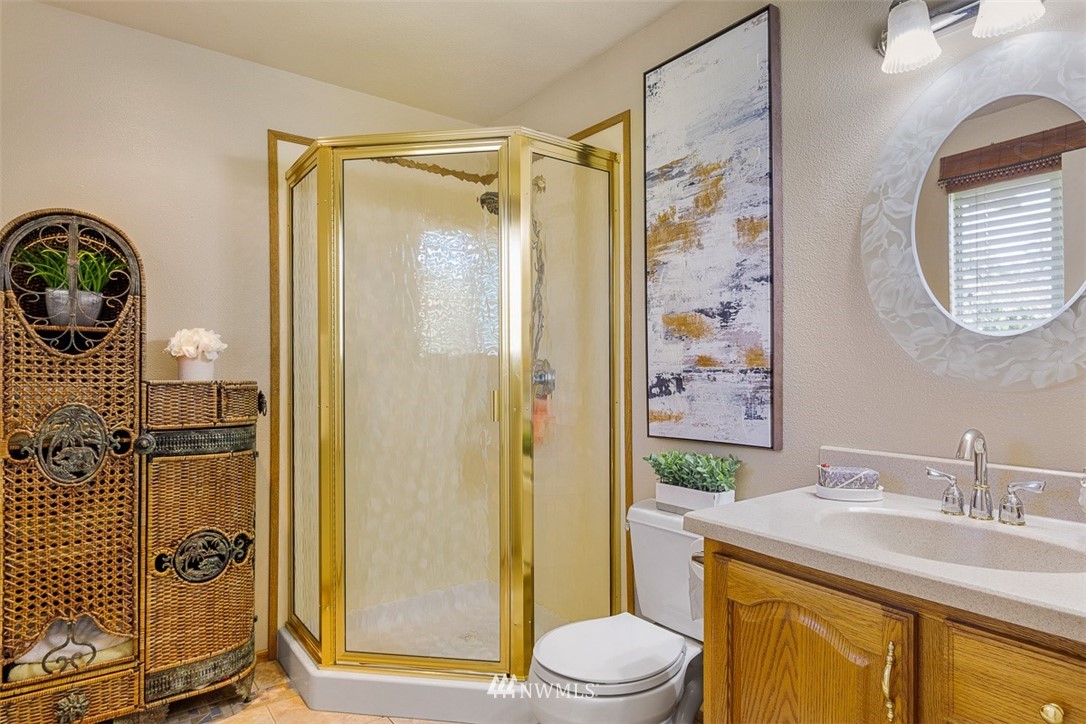 507 South 38th Court Renton, WA 98055 - Photo 17 of 40 a bathroom with a granite countertop sink toilet and shower