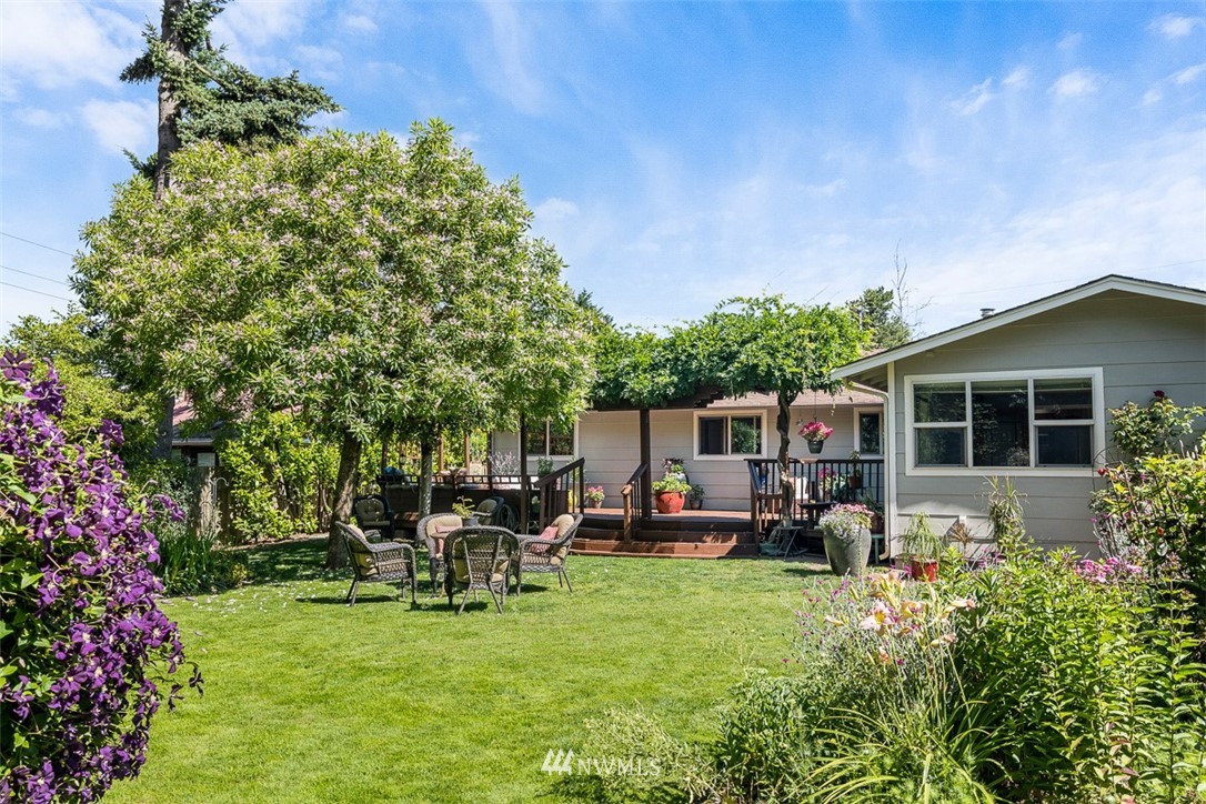 507 South 38th Court Renton, WA 98055 - Photo 25 of 40 a view of a house with backyard sitting area and garden