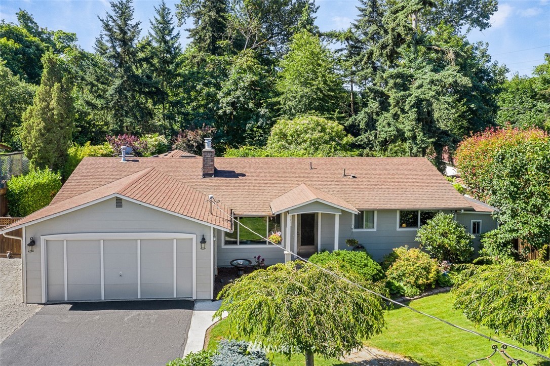 507 South 38th Court Renton, WA 98055 - Photo 36 of 40 a view of a house with a yard plants and large tree