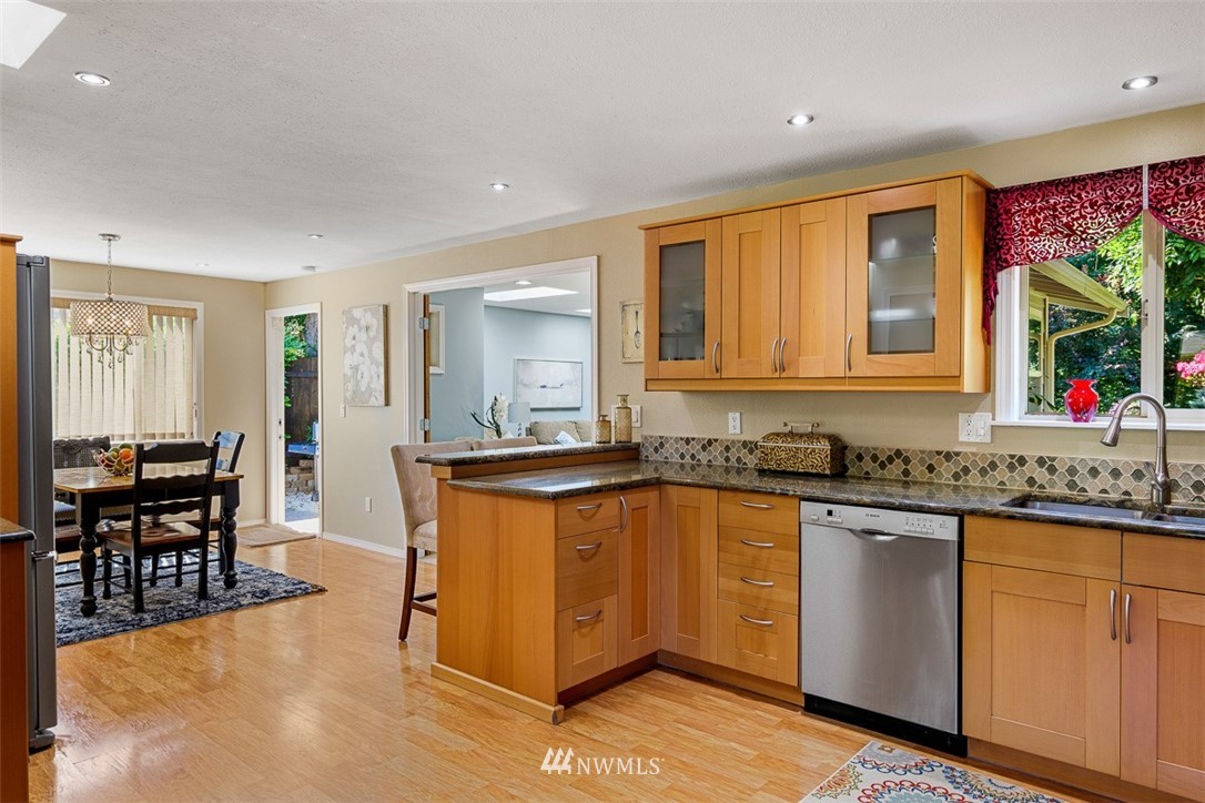 507 South 38th Court Renton, WA 98055 - Photo 8 of 40 a kitchen with granite countertop a sink and cabinets