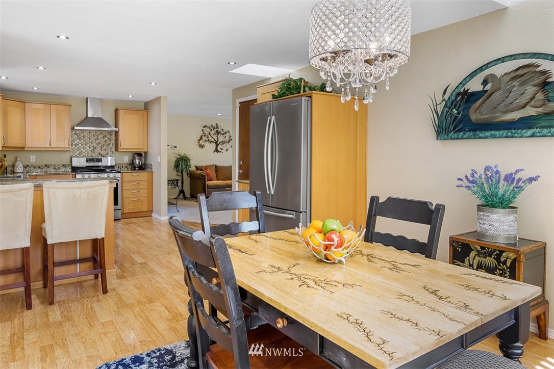 507 South 38th Court Renton, WA 98055 - Photo 10 of 40 a view of a dining room with furniture and chandelier