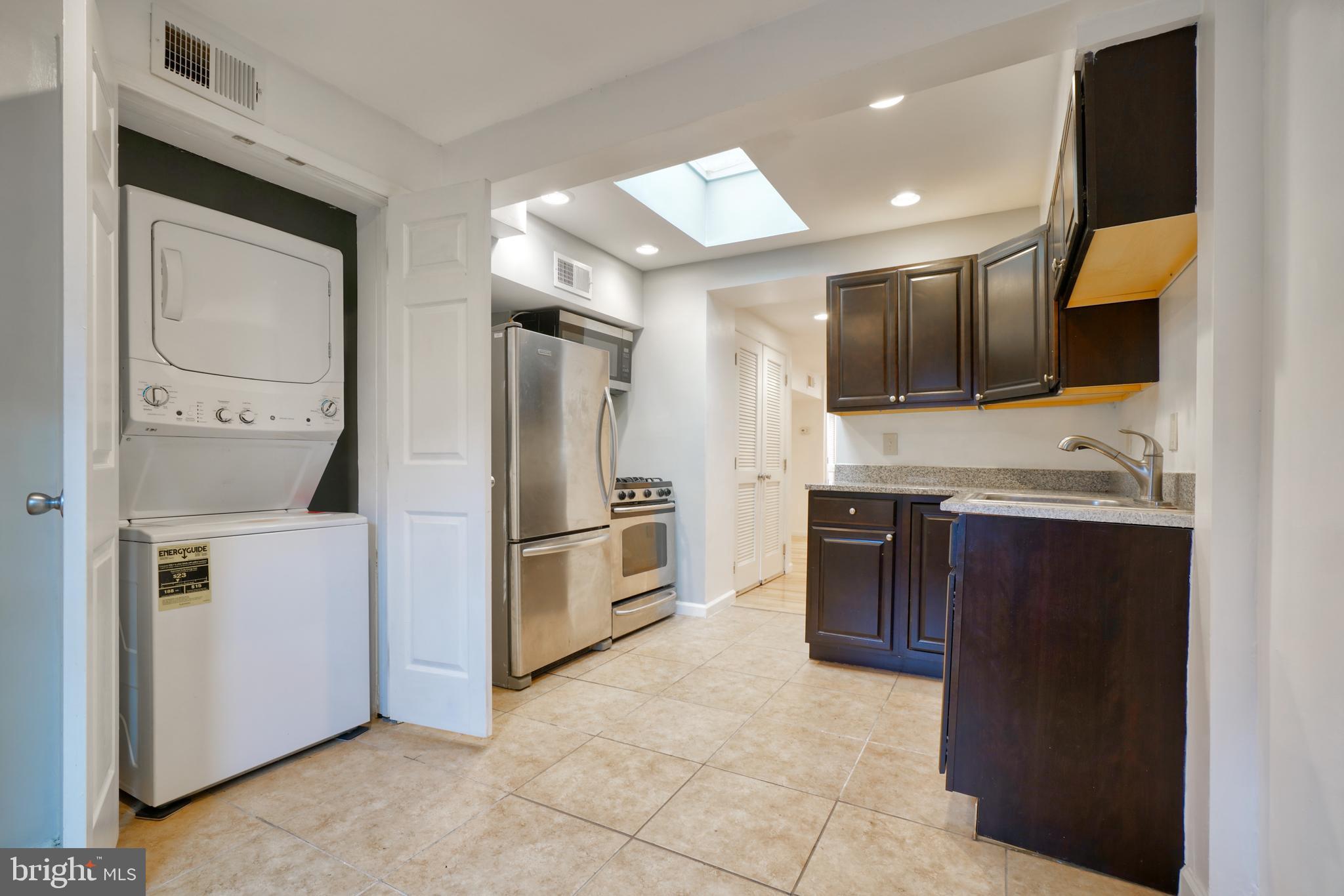1029 Booth Street Baltimore, MD 21223 - Photo 1 of 21 a kitchen with stainless steel appliances a refrigerator and a stove top oven