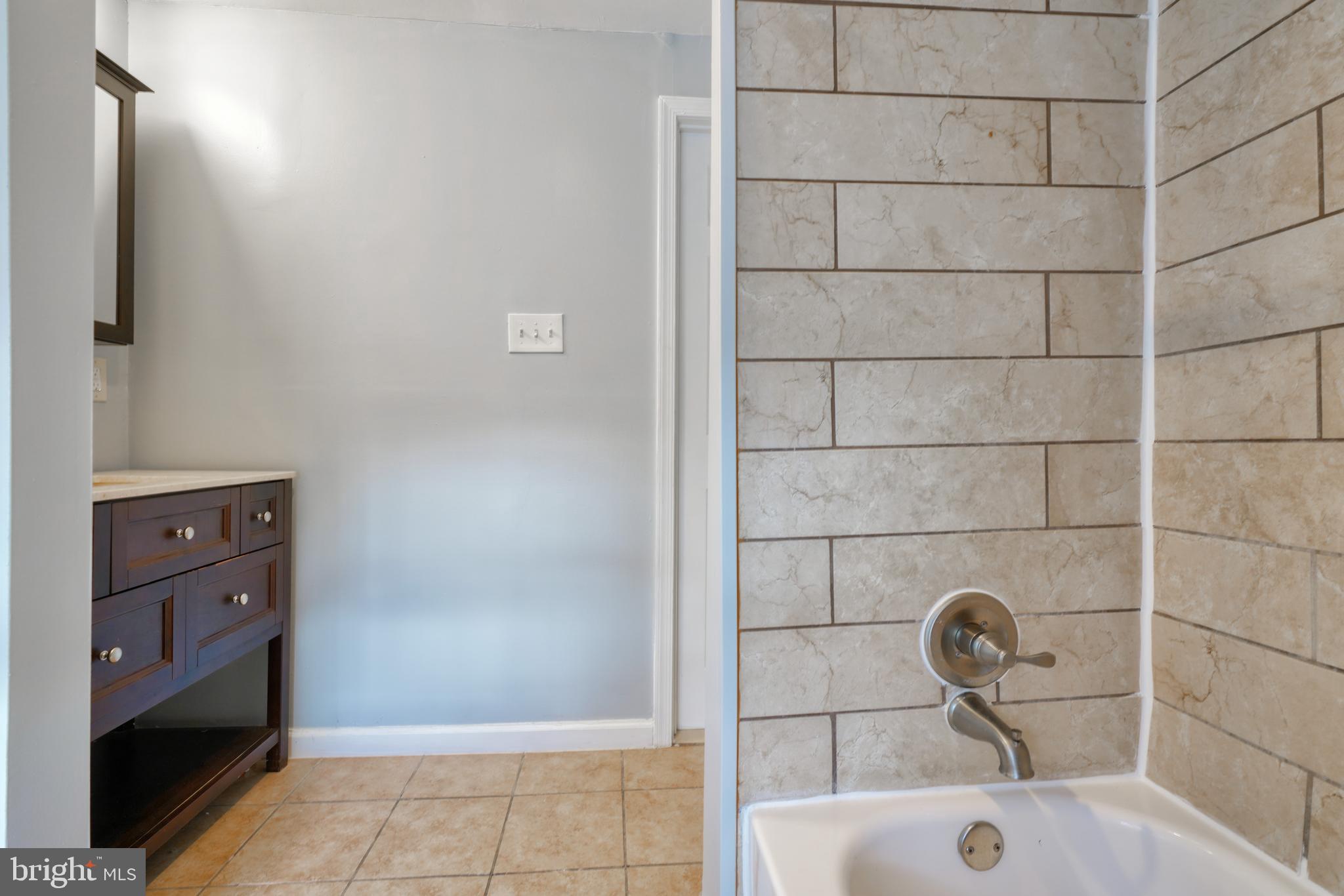 1029 Booth Street Baltimore, MD 21223 - Photo 18 of 21 a bathroom with a sink and a shower
