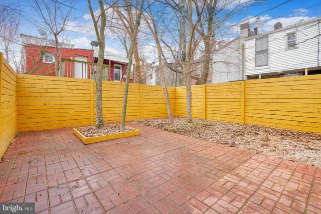 a view of a brick house with a backyard