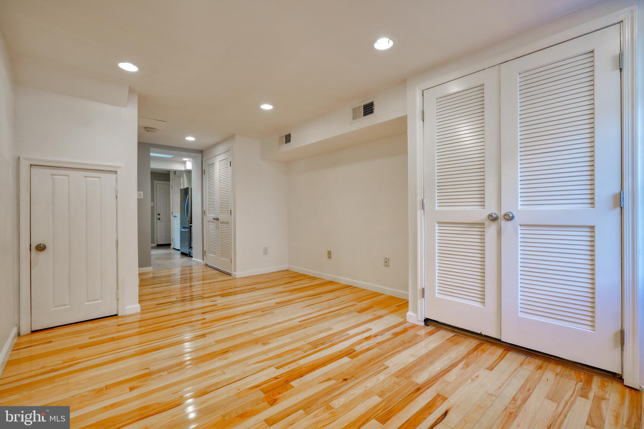 1029 Booth Street Baltimore, MD 21223 - Photo 4 of 21 a view of a livingroom with wooden floor and closet
